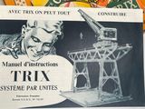 a newspaper with a picture of a man working on a crane