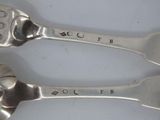 two spoons that are sitting next to each other