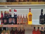 bottles of alcohol are on shelves in a liquor store