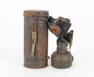 an old gas can with a gas mask on top of it