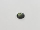 a green tourmaline gemstone on a white surface