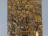a gold plaque depicting a scene from the nativity of jesus