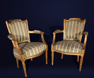 pair of louis xvi style armchairs with striped upholstered upholstered cushions