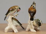 two figurines of birds sitting on top of each other