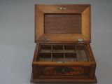 an old wooden box with a glass top sitting on a table