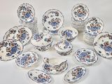 a lot of plates and bowls that are on a table