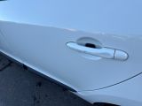a close up of a car door handle on the side of the road