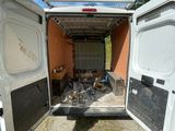 a white van that is parked in the dirt