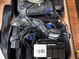 a bag of electronics sitting on a table next to a laptop