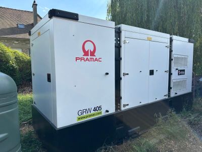 an image of a group of generators sitting on top of a grass covered field
