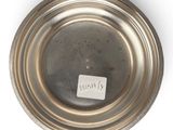 an image of a silver plate with a tag on it