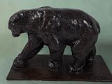 a statue of a bear that is standing on a base