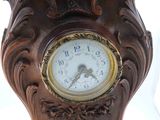 a wooden clock that is sitting on a table