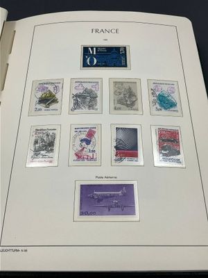 an open book with stamps on it on a table