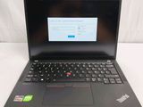 the laptop is open on a white surface with a red button on the keyboard