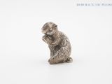 silver figurine of a squirrel sitting on its hind legs