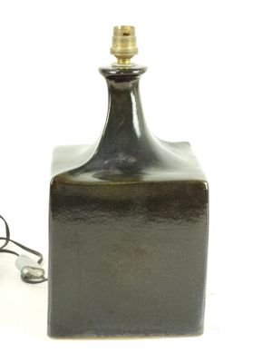 a small black bottle with a light on top of it