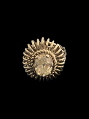a close up of a gold ring with a stone in the center