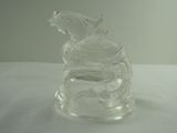 a glass bird that is sitting on top of a glass container