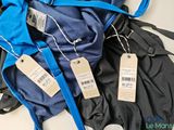 a blue backpack with tags attached to it on a table