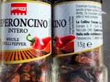 two jars of pepperonio next to each other on a counter