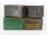 three old metal boxes stacked on top of each other on a white surface