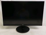 a black computer monitor sitting on top of a white table