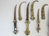 several different types of knives are displayed on a white surface