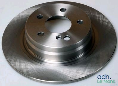 a close up of a brake disc on a white surface