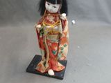 an image of a doll of a woman in a kimono outfit