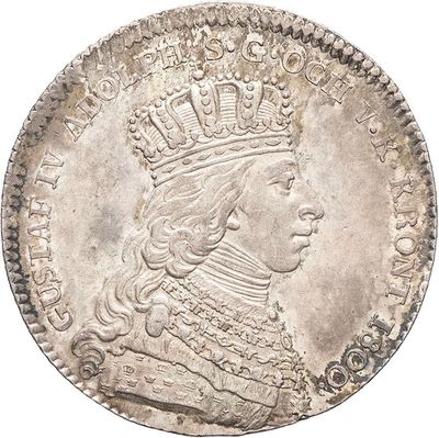 a silver coin with a crown on top of it
