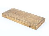 an old wooden box with a handle on a white surface