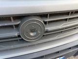 a close up of a car ' s grille with a number plate on it