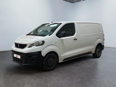 the white van is parked in a large room with a ceiling fan