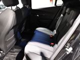 the back seats of a car with a cooler in the back of it
