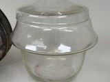 a glass jar with a lid sitting next to a glass jar with a lid