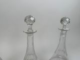 three clear glass decanters sitting next to each other on a table