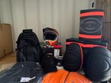 many bags of luggage sitting on top of a cardboard box