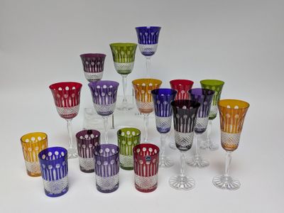 many different colored wine glasses sitting on a table