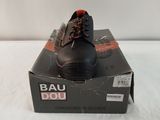 men ' s bau shoes in a box on a white surface