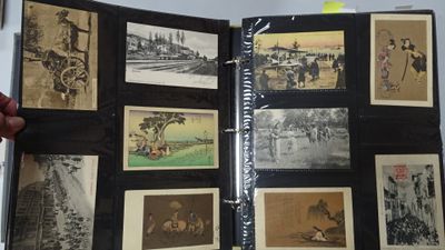 a person holding a book with pictures of people on it