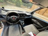 a dashboard of a small car with a steering wheel