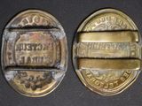 two antique brass buttons with the names of different countries on them