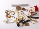 a lot of jewelry on a white surface with a ruler