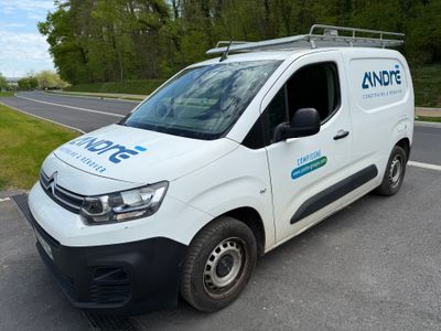 a white van that is parked on the side of the road