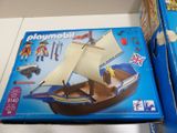 a box of playmobil and a box of toys on a table