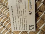 a label on a woven basket with a tag attached to it