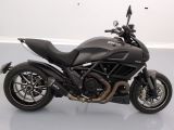 motorcycle parked in a room with a white floor and a white wall