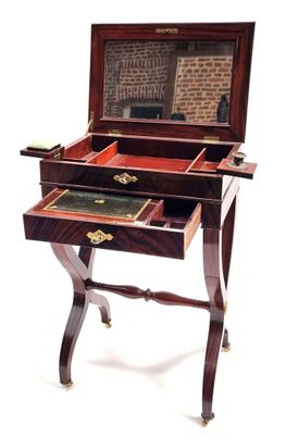 a small desk with a mirror on top of it