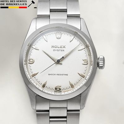 a watch that is sitting on a white surface
